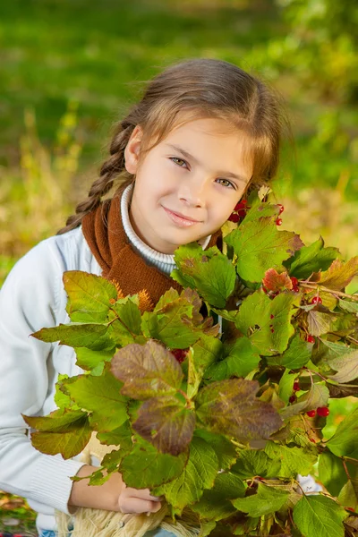 Little girl with red viburnum — Stock Photo, Image