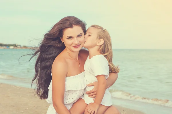 Mother and her little daughter hugging.