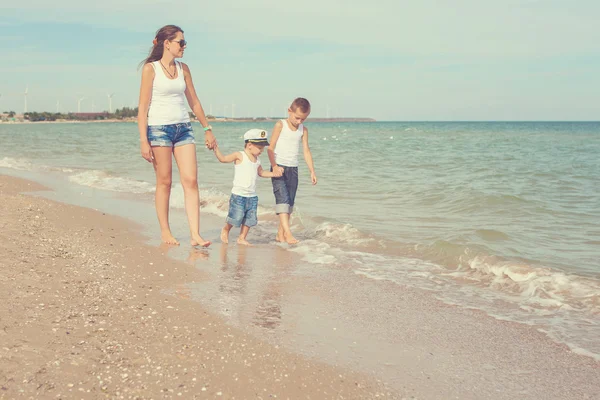 Mother and her two sons having fun on the beach — Stock Photo, Image