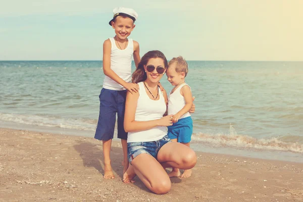 Mutter und ihre beiden Söhne amüsieren sich am Strand — Stockfoto