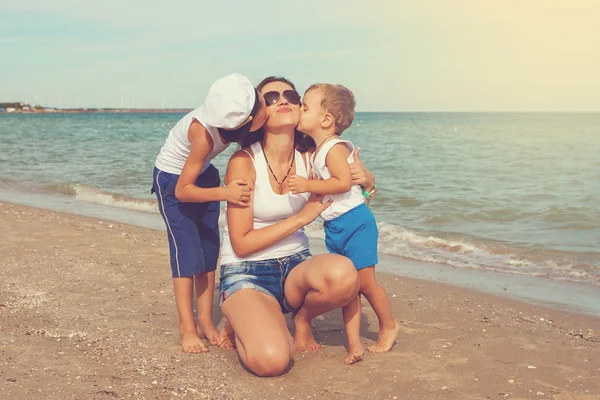 Mother and her two sons having fun on the beach — Stock Photo, Image