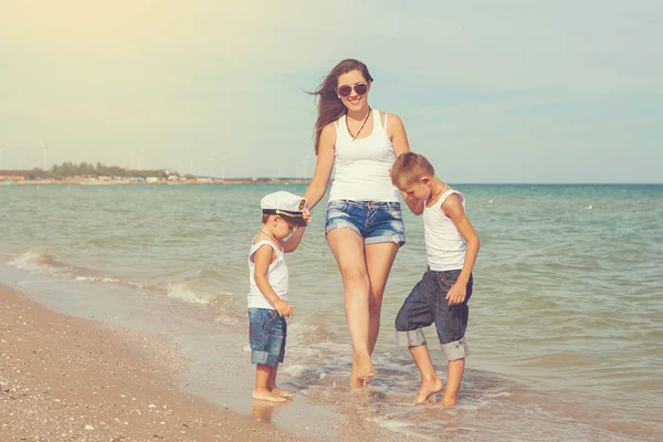 Mother and her two sons having fun on the beach — Stock Photo, Image