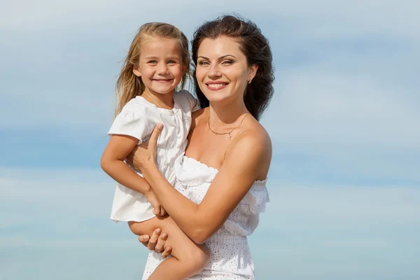 Happy beautiful mother and daughter enjoying beach time — Stock Photo, Image