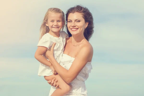 Happy beautiful mother and daughter enjoying beach time — Stock Photo, Image