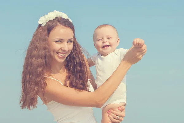 Happy beautiful mother and son enjoying beach time — Stock Photo, Image