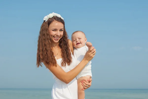 Happy beautiful mother and son enjoying beach time — Stock Photo, Image