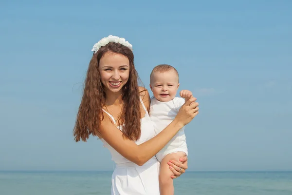 Happy beautiful mother and son enjoying beach time — Stock Photo, Image