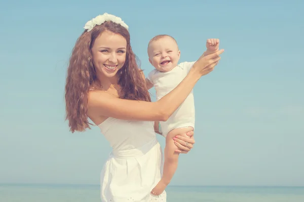 Happy beautiful mother and son enjoying beach time — Stock Photo, Image