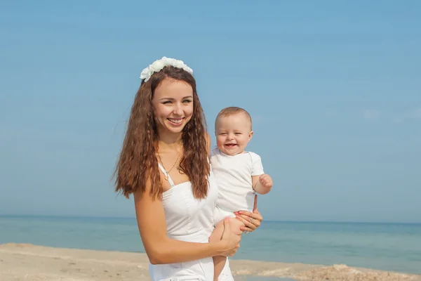 Happy beautiful mother and son enjoying beach time — Stock Photo, Image