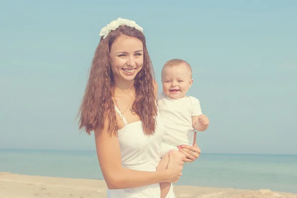 Happy beautiful mother and son enjoying beach time — Stock Photo, Image