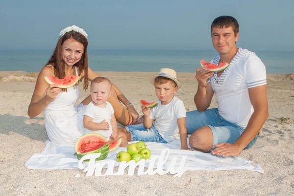 Οικογένεια με καρπούζι στην παραλία — Φωτογραφία Αρχείου