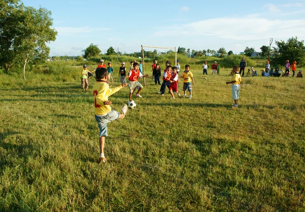 Asian kid playing football, physical education — Stock Photo, Image