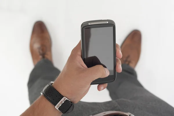 Empresário segurando um telefone celular — Fotografia de Stock