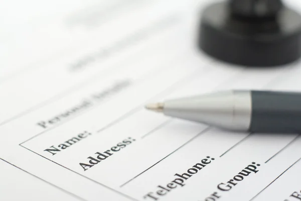 Form, pen and stamp on the desk — Stock Photo, Image