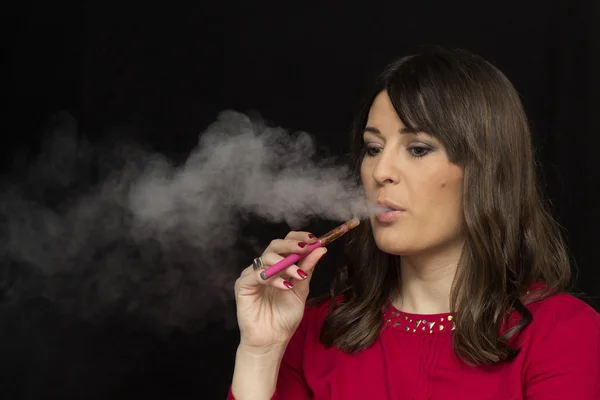 Woman smoking a electronic cigarette — Stock Photo, Image