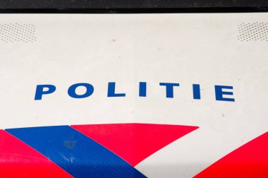 Arnhem, Netherlands - April 27, 2021: Closeup of a logo of the dutch police on a car