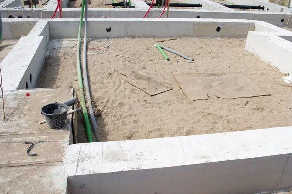 Foundation of concrete of a house without a floor with some pipes in the Netherlands