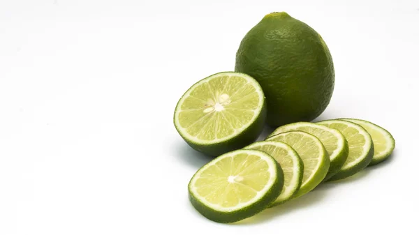 Isolated fresh lime and slices on white background with copy spa — Stock Photo, Image
