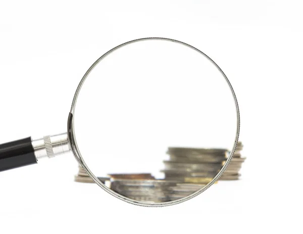 Magnifier and coins — Stock Photo, Image