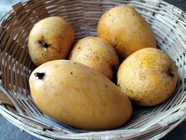 Taze sarı mango sepete koy