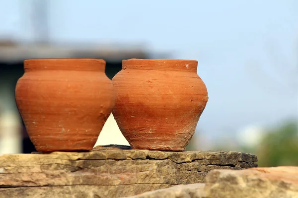 red clay pot put on a stone