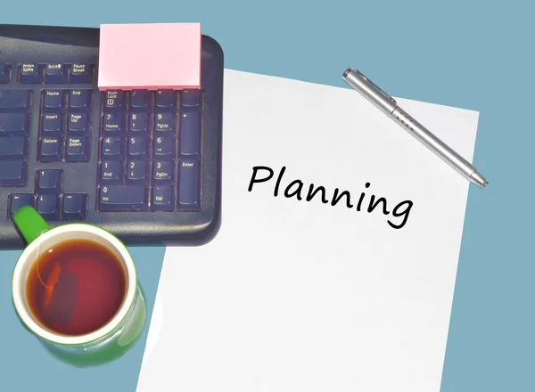 Keyboard with text  on table with tea, calculator and pen — Stock Photo, Image