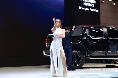 Bangkok Thailand August 24 2019 blur Unidentified Pretty is presenting a car for sale at the Bangkok Motor Show clipart