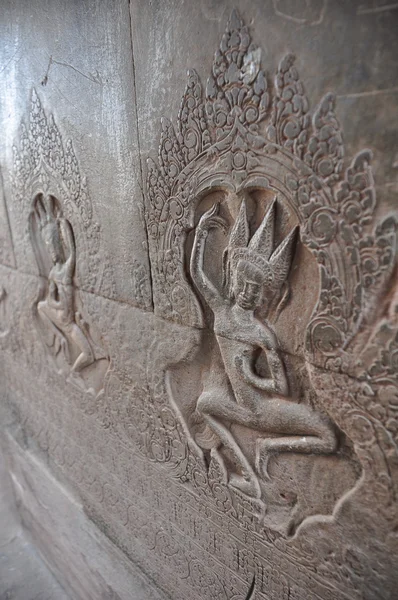 Beautiful dancing Apsaras an old Khmer art carvings on the wall