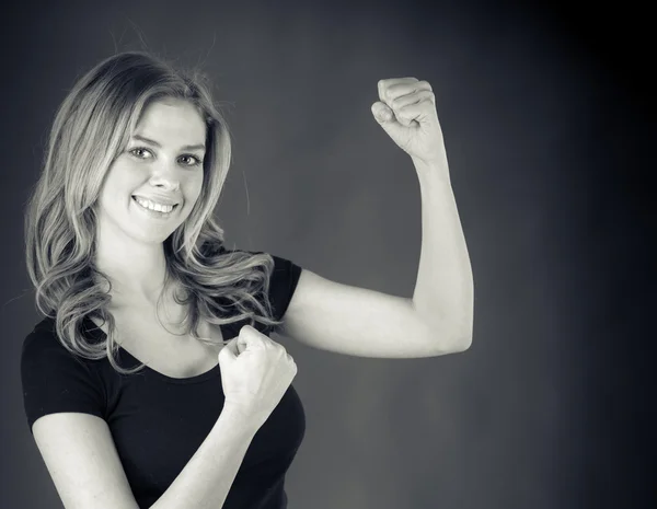 Woman celebrating success with fists up