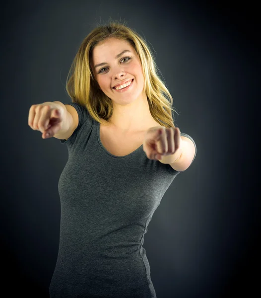 Woman looking at camera and pointing with fingers — Stock Photo, Image