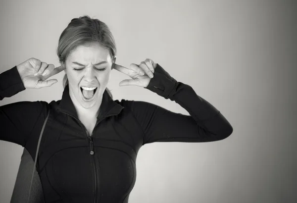 Woman plugging ears with fingers — Stock Photo, Image