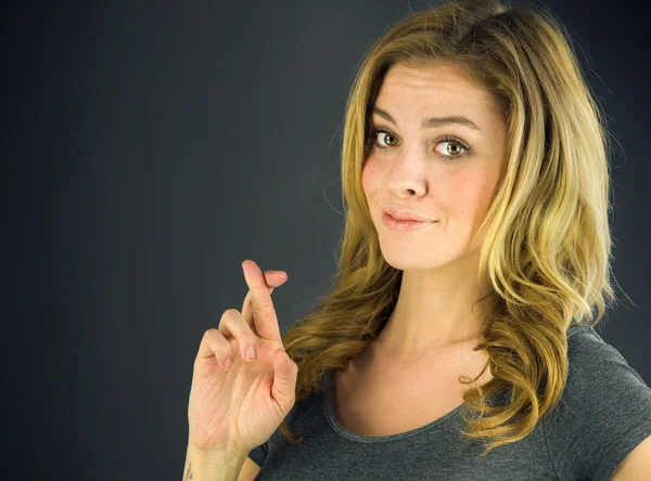 Woman with fingers crossed for luck — Stock Photo, Image