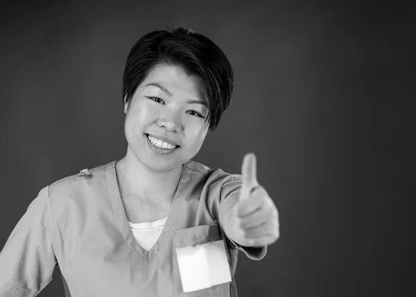 Woman gesturing thumb up sign — Stock Photo, Image