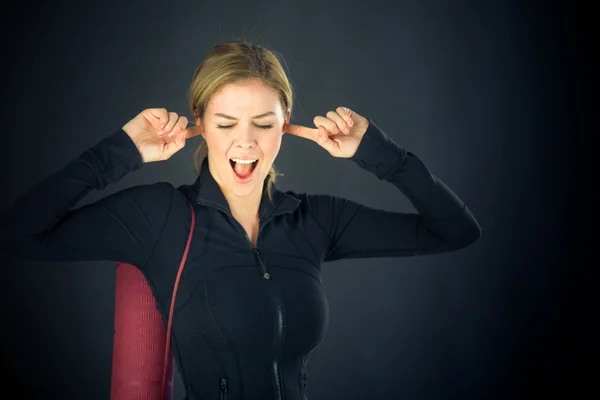 Woman plugging ears with fingers — Stock Photo, Image