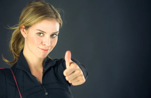 Woman gesturing thumb up sign — Stock Photo, Image