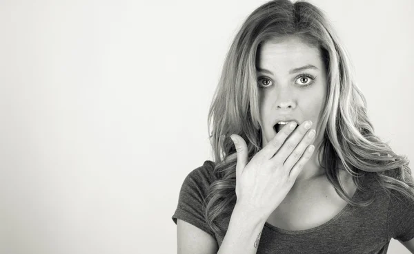 Shocked woman covering her mouth by hand — Stock Photo, Image