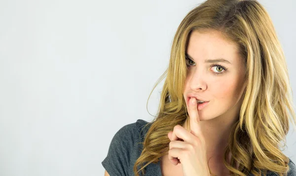 Woman asking for silence with finger on lips — Stock Photo, Image