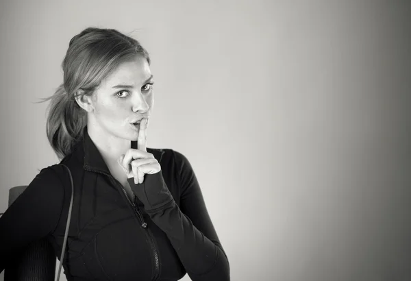 Woman asking for silence with finger on lips — Stock Photo, Image