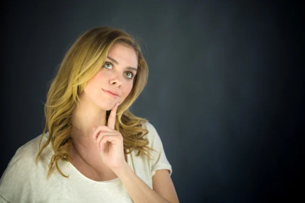 Woman thinking with finger on chin — Stock Photo, Image