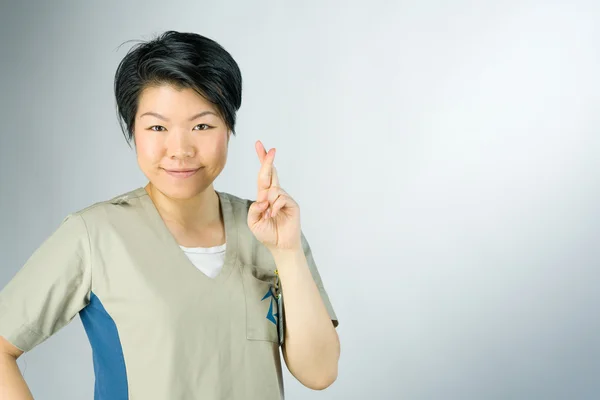 Woman with fingers crossed for luck — Stock Photo, Image