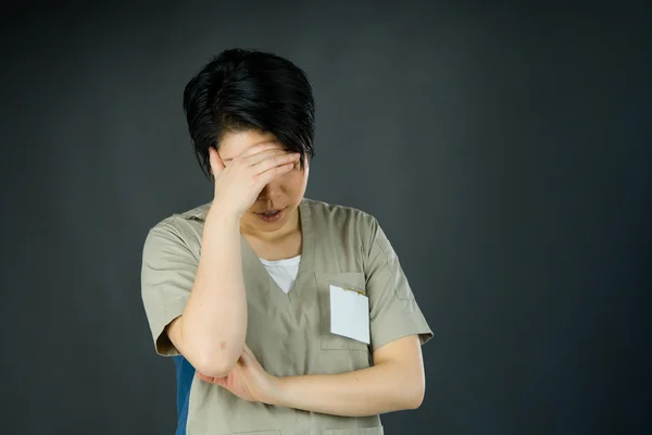 Woman ashamed hiding face in hand — Stock Photo, Image