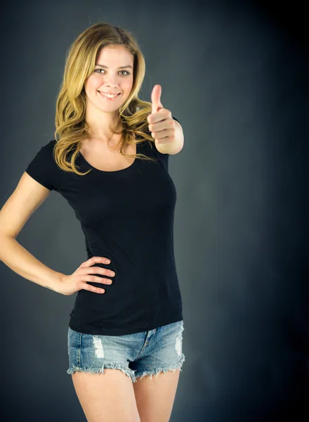 Woman gesturing thumb up sign — Stock Photo, Image