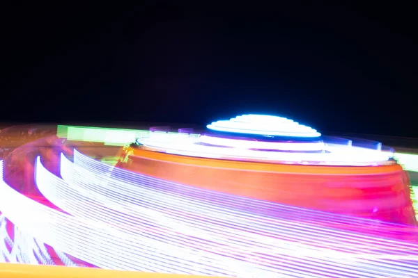 View of blurred motion roller coaster against sky