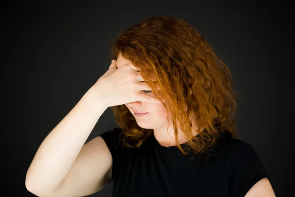 Model ashamed hiding face in hand — Stock Photo, Image