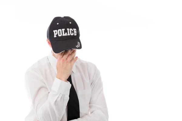 Polizist schämt sich, Gesicht in der Hand zu verstecken — Stockfoto