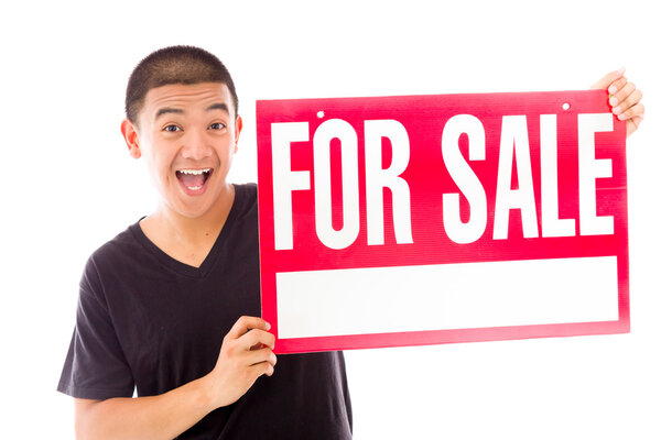 Model holding a For sale sign