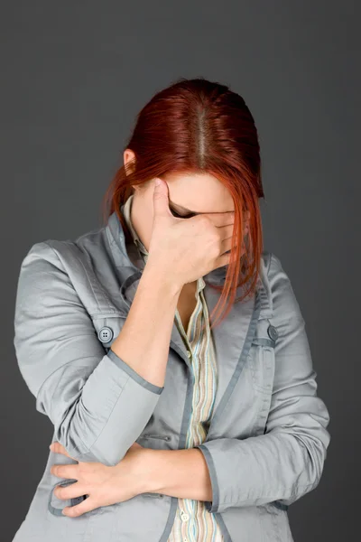 Model ashamed hiding face in hand Stock Photo