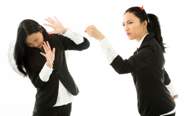 Angry devil side of a young Asian businesswoman punching the white angel isolated on white background