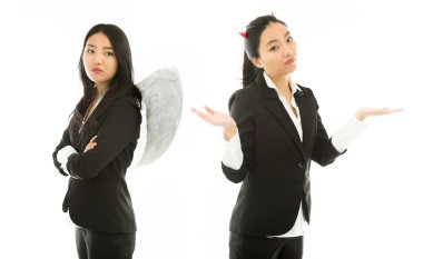 Angry angel side and devil side of a young Asian businesswoman standing back to back isolated on white background