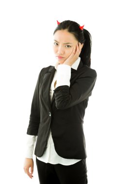 Devil side of a young Asian businesswoman standing with her hands on cheek and looking sad isolated on white background